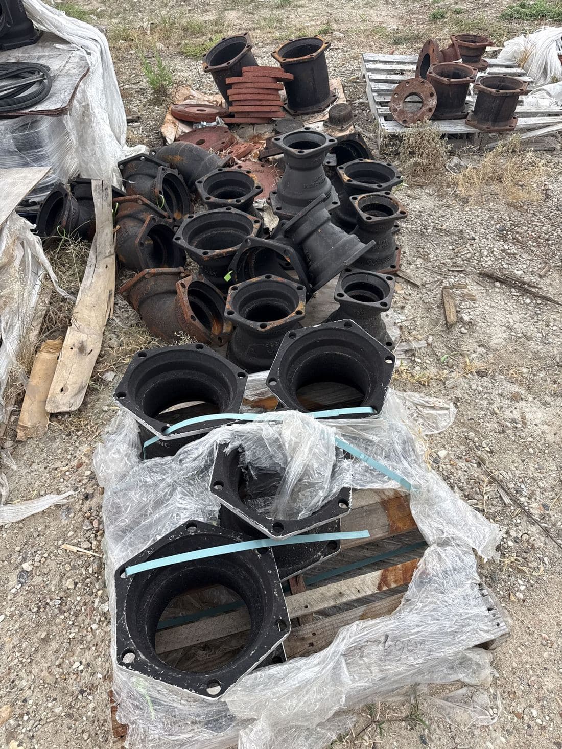 Ductile iron mechanical-joint fittings arranged on a wooden pallet