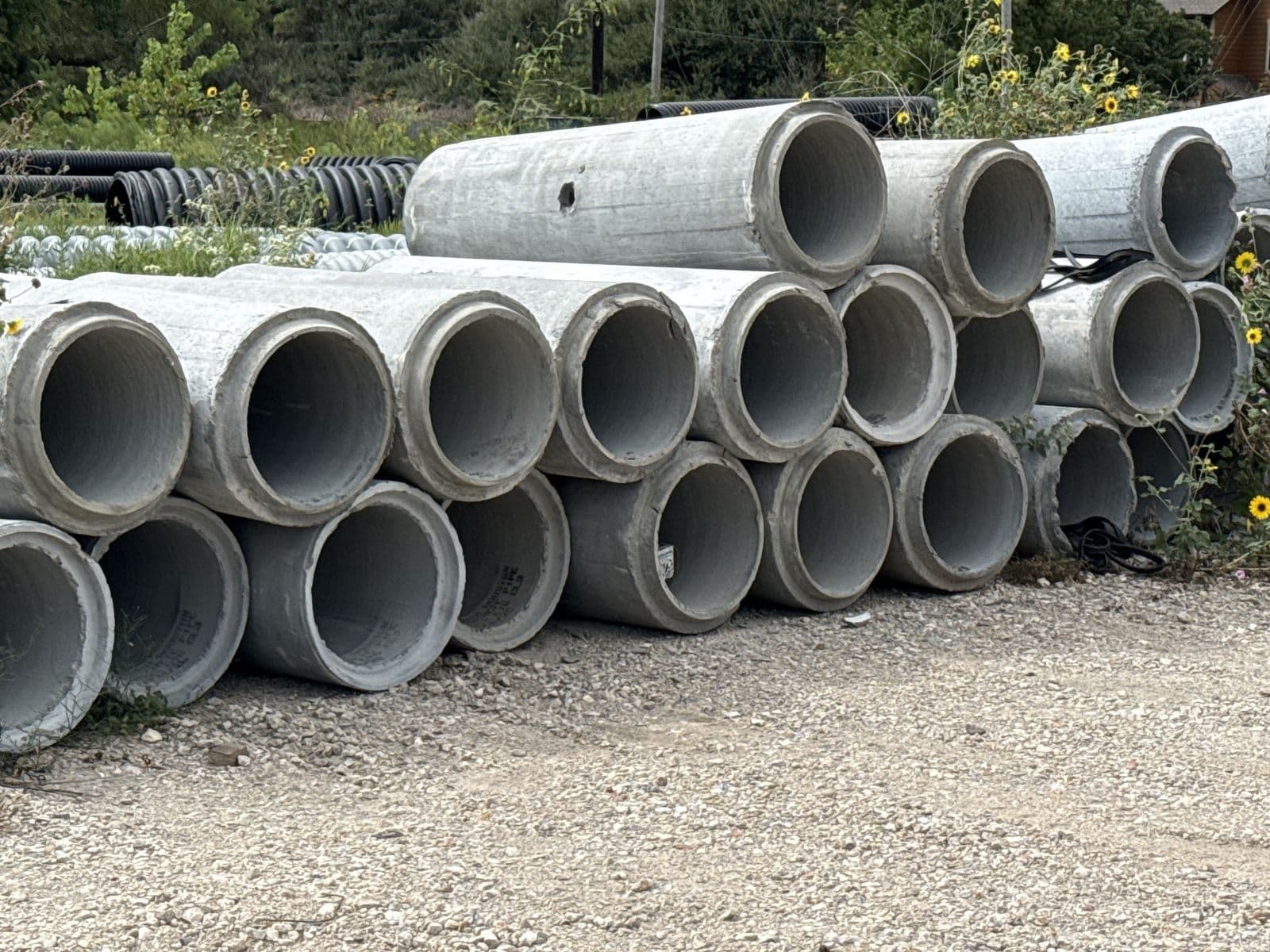 Stacks of reinforced concrete pipe in an outdoor yard